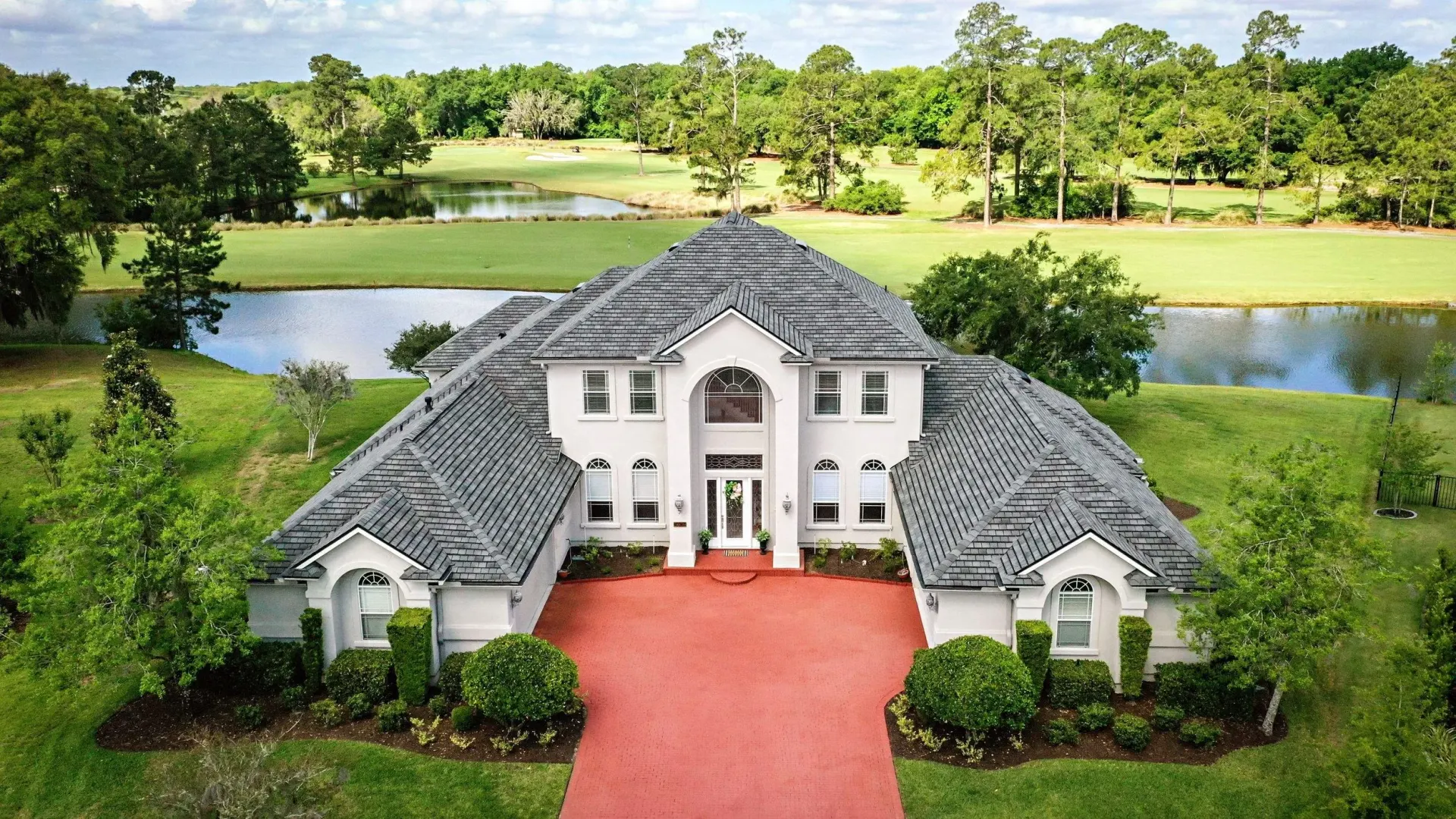 Aerial view of a shingle roof on a large home, from the JADA homepage